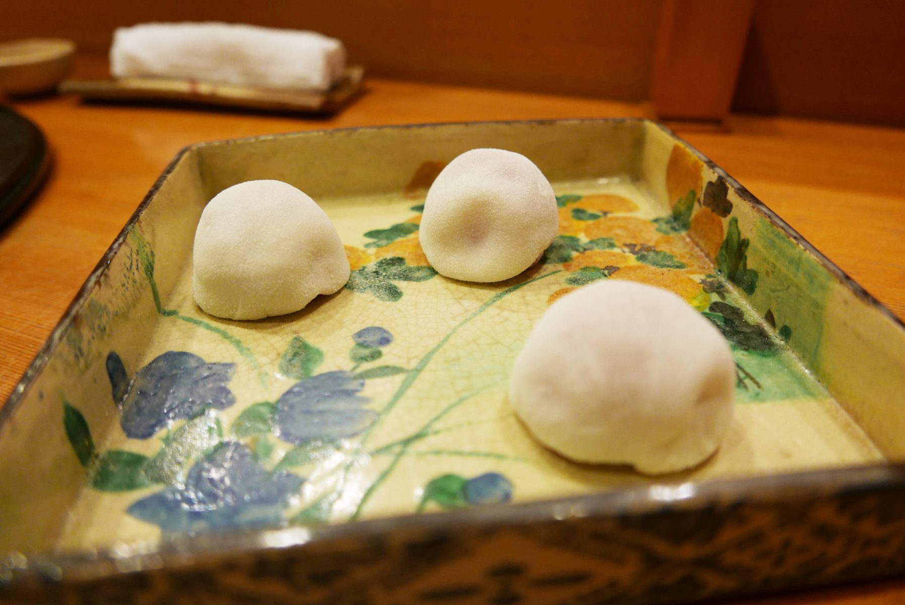 Daifuku dough enrobed strawberries served on the antique plate at Suzue,Kyoto.